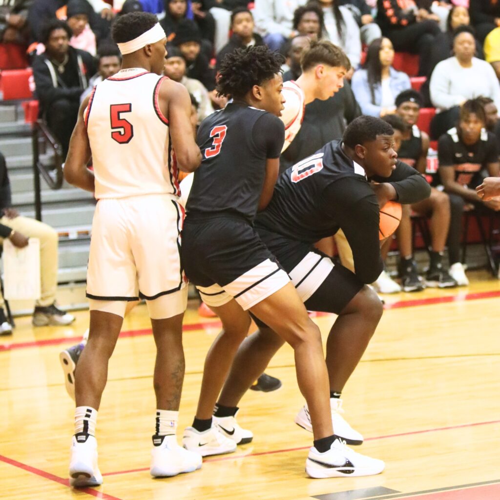 Hawthorne's Kyler Ingram (10) secures a rebound against Williston. Photo by C.J. Gish