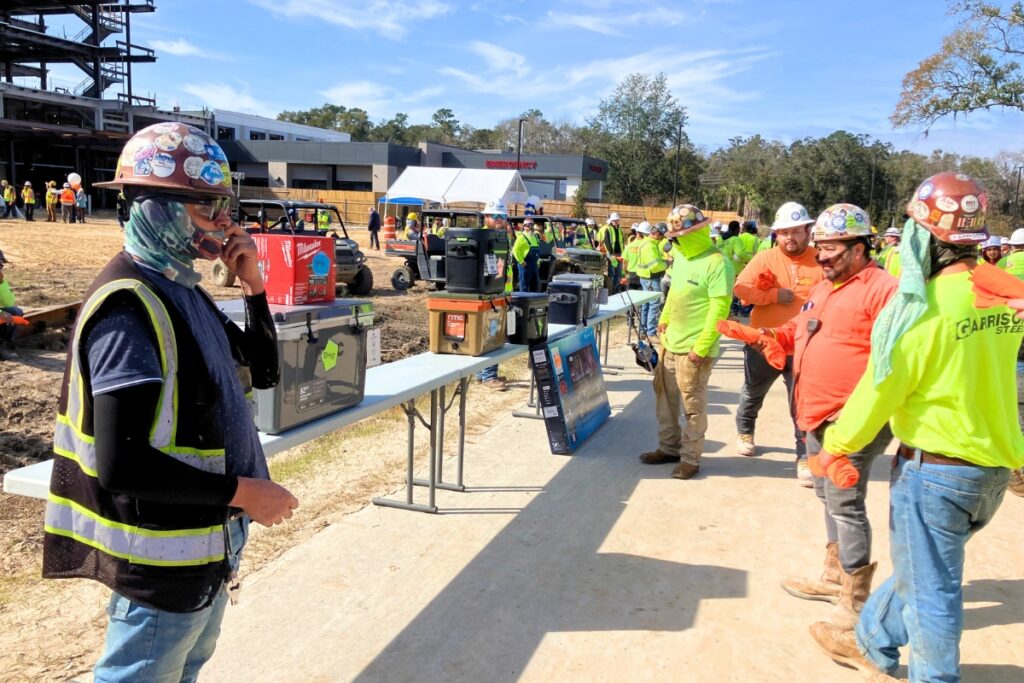 Hospital construction crew members participate in raffle at Topping Out ceremony. Photo by Lillian Hamman