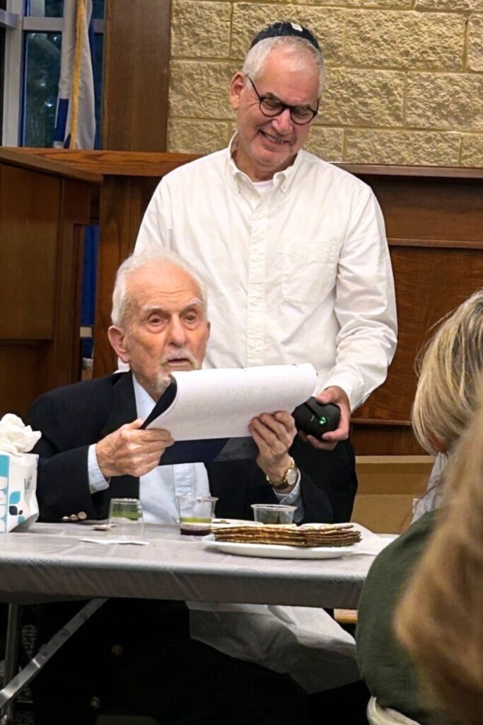 Larry Jaffe at 2024 Passover services at Temple Shir Shalom with Rabbi Michael Joseph peering over his shoulder. Photo courtesy of Vera Rabino
