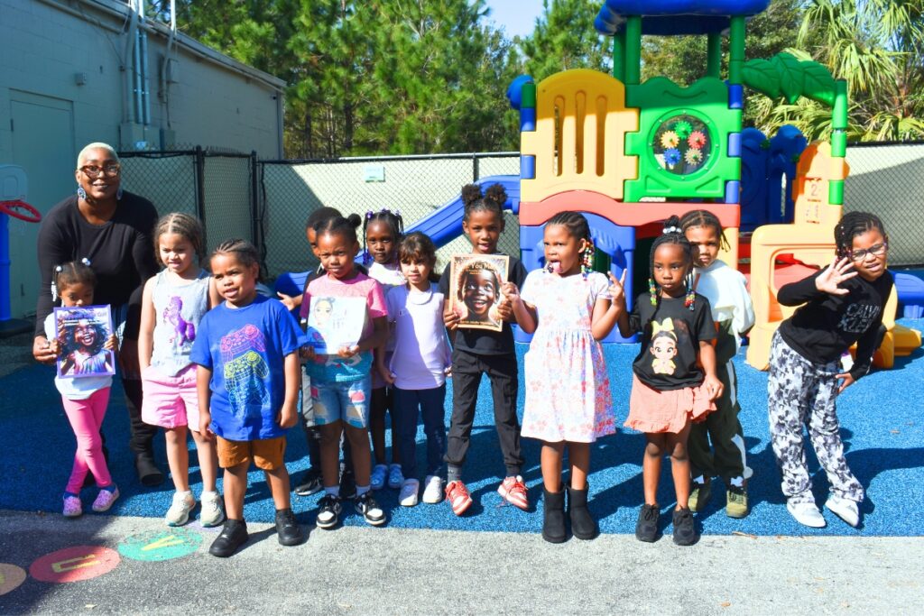 ECS students pose with Takira Washington on the playground. Photo by Glory Reitz