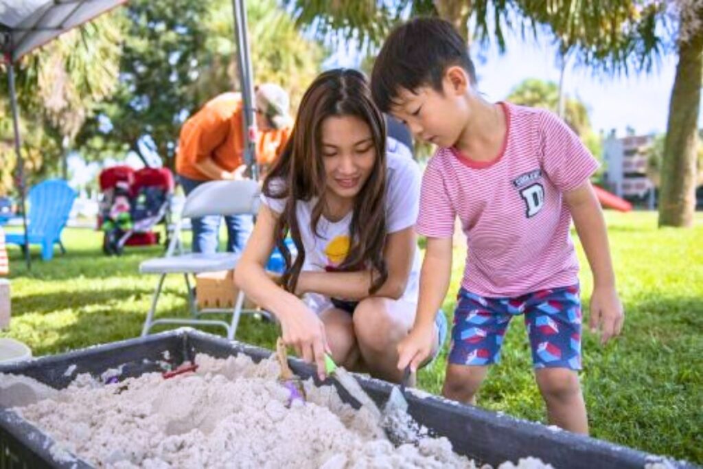 Florida Museum visitors look for fossils in a model dig pit. Photo by Kristen Grace-Florida Museum
