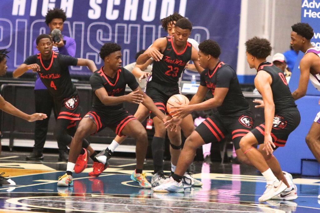 Fort White's Darion Brinson (5) snags a rebound against Crossroad Academy (Quincy) in the Rural State Semifinals. Photo by C.J. Gish