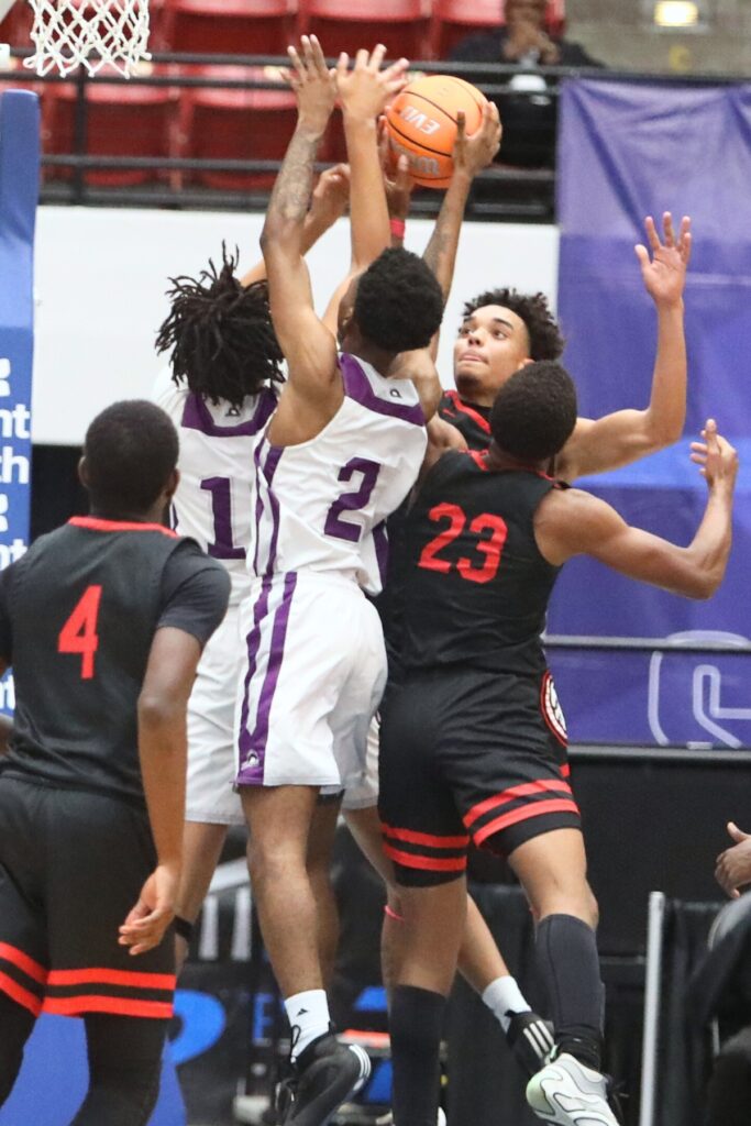 Fort White's Kendal Henry (23) and Tafari Moe (0) battle for a rebound against Crossroad Academy (Quincy) in the Rural State Semifinals. Photo by C.J. Gish