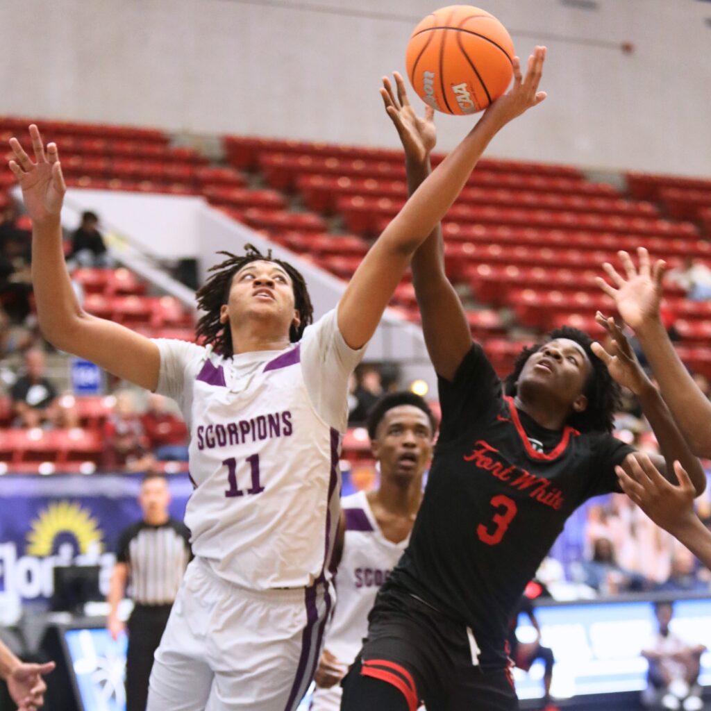 Fort White's Tre Halloway (3) battles for a rebound against Crossroad Academy (Quincy) in the Rural State Semifinals. Photo by C.J. Gish