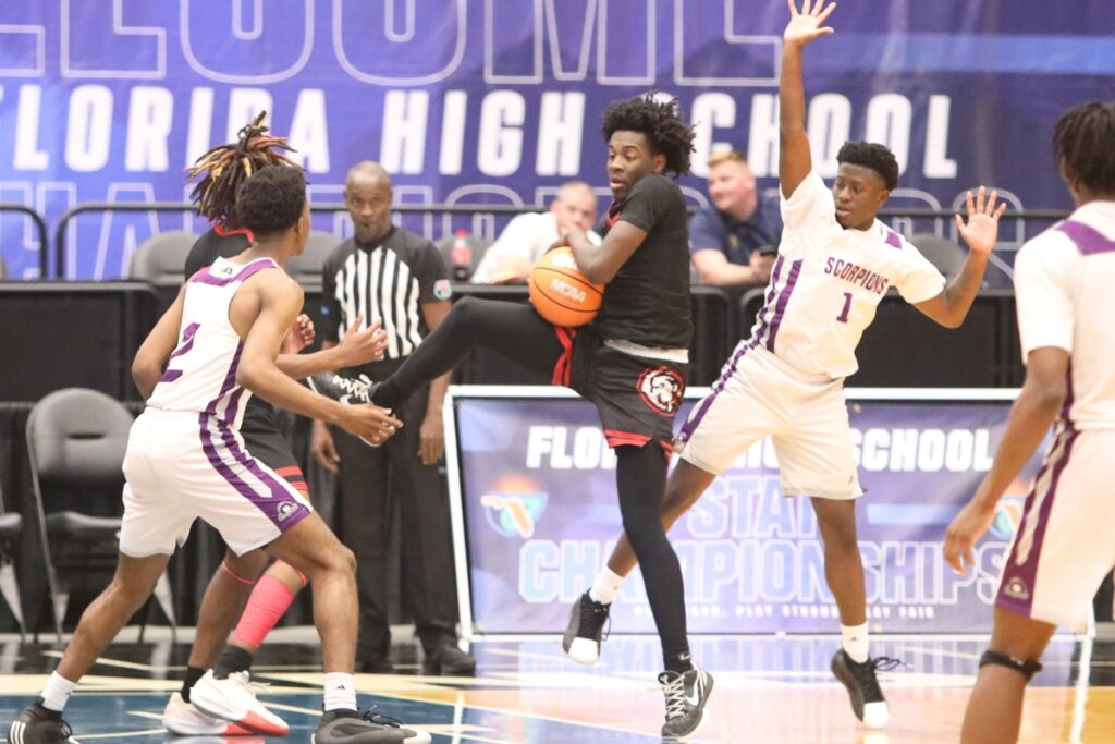 Fort White's Tre Halloway (3) with a rebound against Crossroad Academy (Quincy) in the Rural State Semifinals. Photo by C.J. Gish