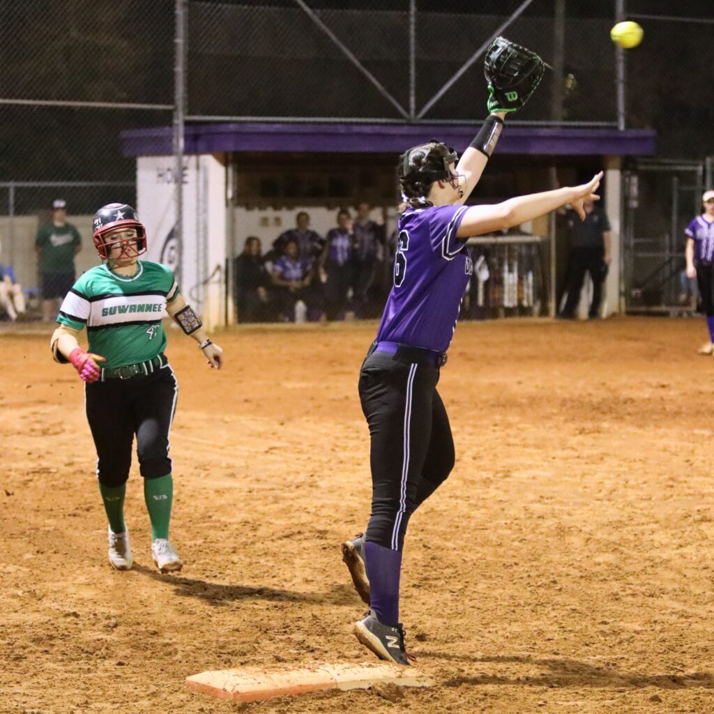Gainesville's Adriana Koralewski (16) gets Suwannee's Maylee Gabey (47) out at first base in the top of the fourth inning. Photo by C.J. Gish