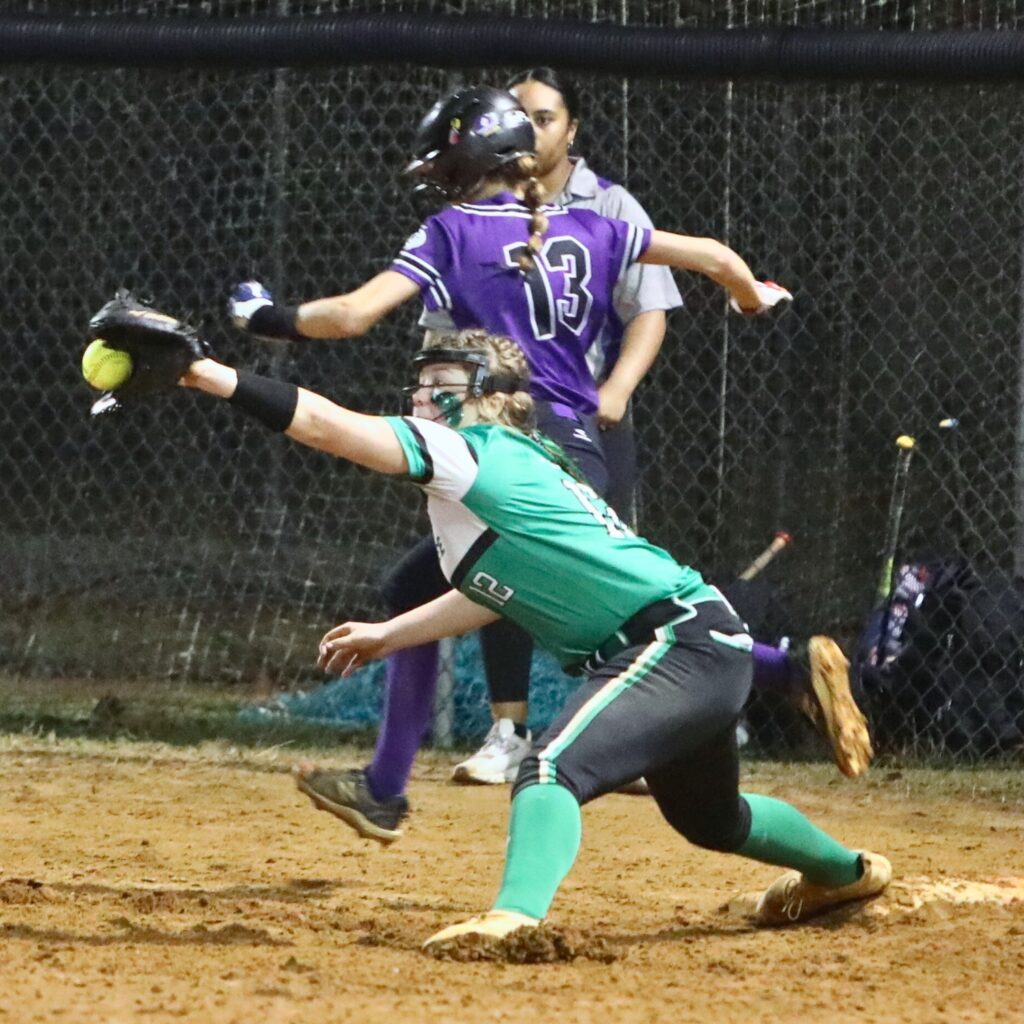 Gainesville's Josie Kirwan (13) beats the throw to first for a single against Suwannee in the bottom of the fourth inning. Photo by C.J. Gish
