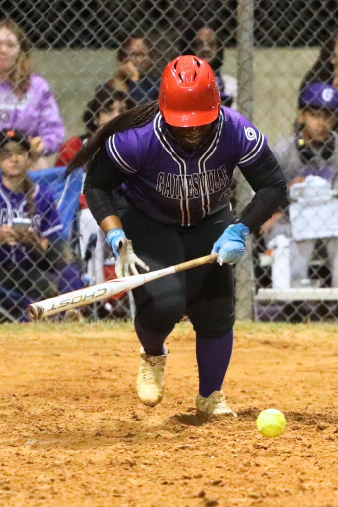 Gainesville's Rihanna Williams (9) lays down a bunt to advance McKenna O’Sullivan to third base in the botom of the third inning against Suwannee. Photo by C.J. Gish