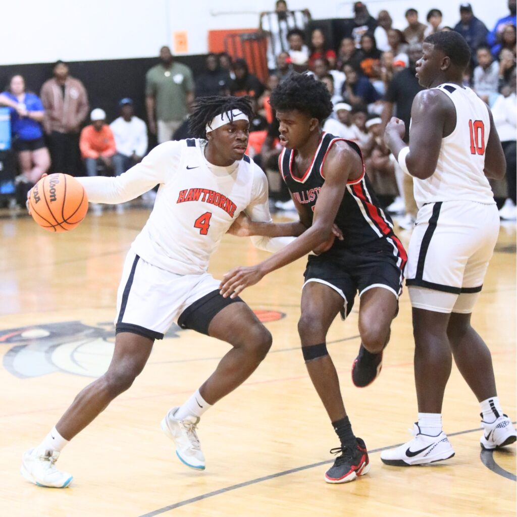 Hawthorne's Chasion Wilson (4) tries to get around Williston's Joel Washington (0). Photo by C.J. Gish