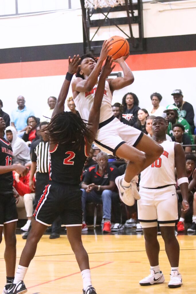 Hawthorne's Decarion Debose (3) puts up a shot against Williston's Jaden Magee (2). Photo by C.J. Gish