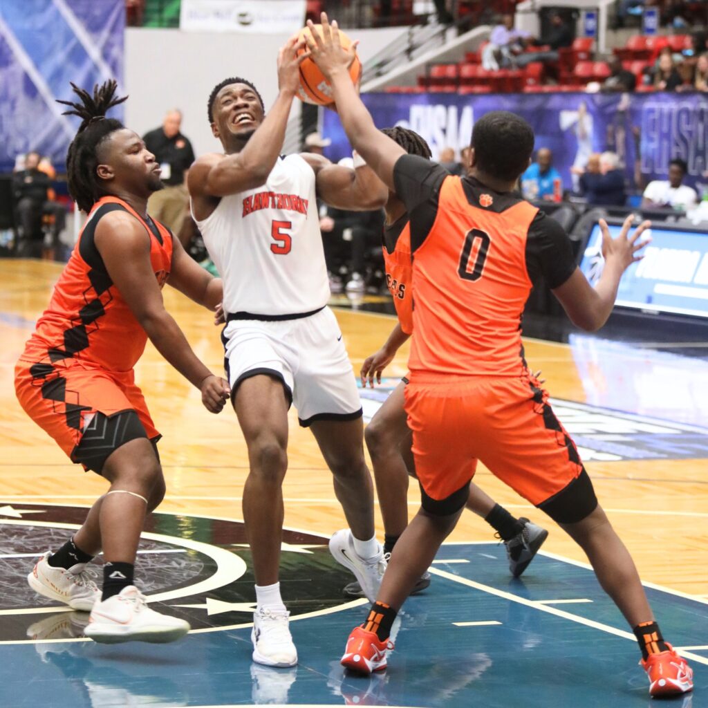 Hawthorne's Demetrius Brown (5) drives to the basket against Graceville in the Rural State Semifinals. Photo by C.J. Gish