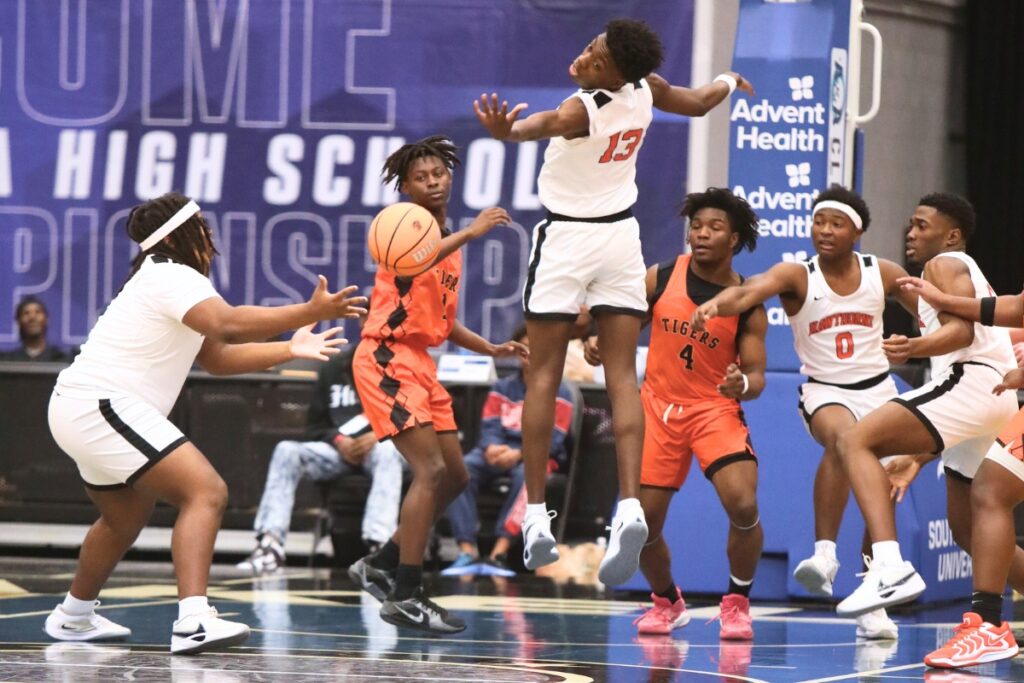 Hawthorne's Frandon Saintleur (13) and Delvis Eason (11) go for a rebound against Graceville in the Rural State Semifinals. Photo by C.J. Gish