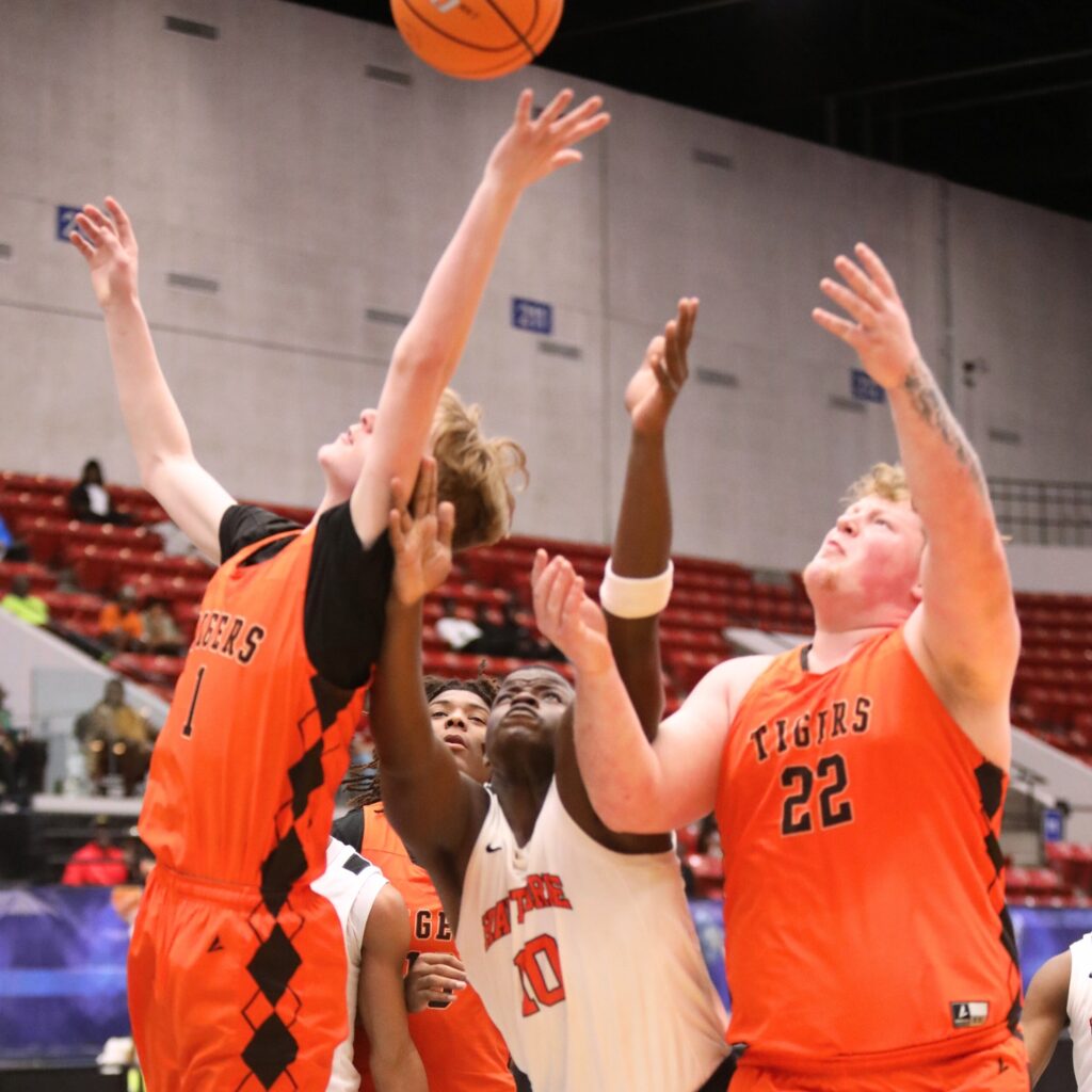 Hawthorne's Kyler Ingram (10) batles for a rebound against Graceville in the Rural State Semifinals. Photo by C.J. Gish 1 (1)