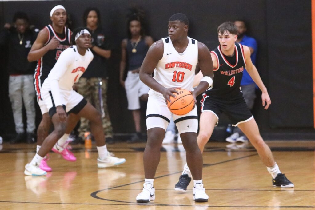 Hawthorne's Kyler Ingram (10) looks to pass against Williston's Adam Henderson (4). Photo by C.J. Gish