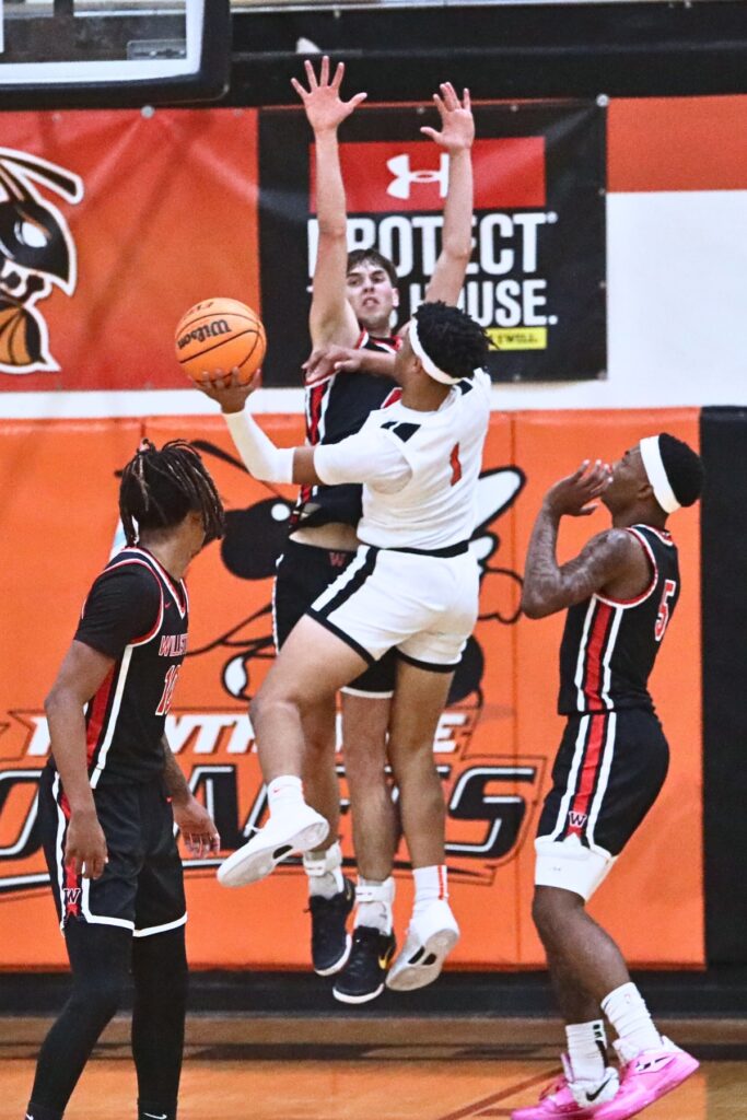 Hawthorne's Leland Johnson (1) puts up a shot against Williston's Adam Henderson (4). Photo by C.J. Gish