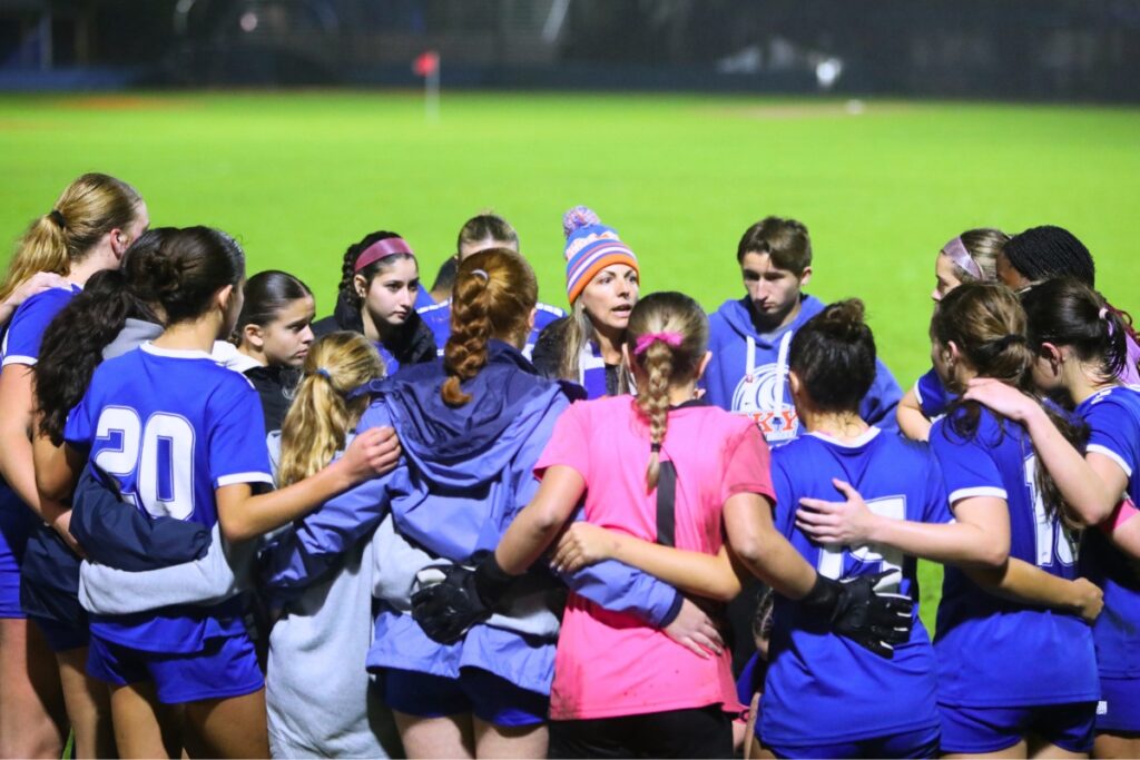 P.K. Yonge coach Rebecca Shackow (in stocking cap) talks to her team prior to penalty kicks against the Episcopal School of Jacksonville. Photo by C.J. Gish