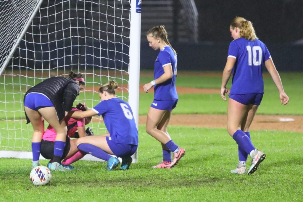 P.K. Yonge goalkeeper Norah Pancoast (pink jersey) is consoled by teammates after the Lady Blue Wave lost on penalty kicks to against the Episcopal (Jacksonville). Photo by C.J. Gish