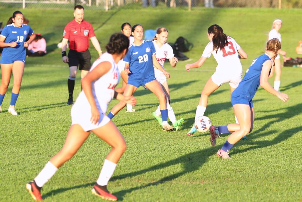 P.K. Yonge's Bella Young (20) finds Faith Hardy (2) for a goal against Lafayette (Mayo). Photo by C.J. Gish 1