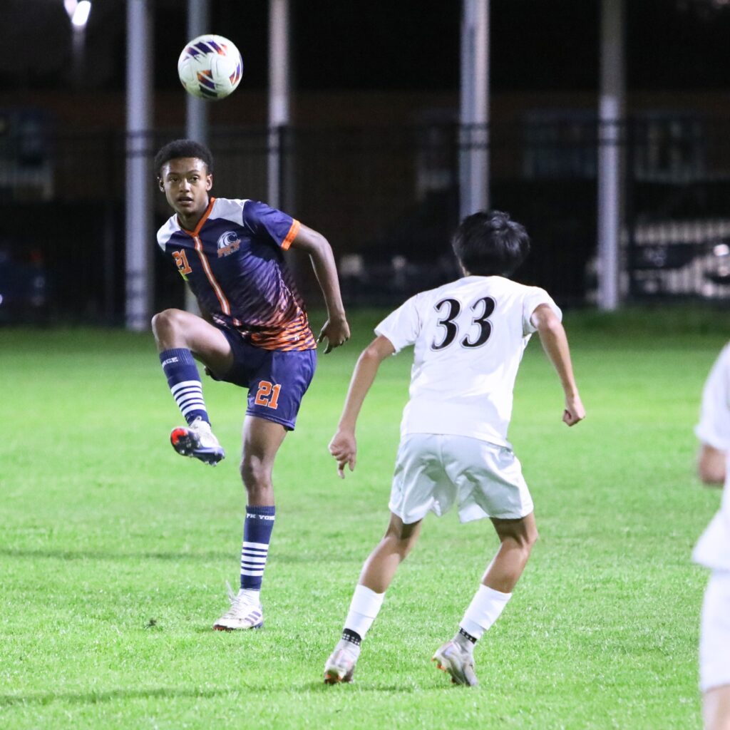 P.K. Yonge's Ethan Bertrand (21) with a pass against Williston's Adrian Celestino (33) . Photo by C.J. Gish