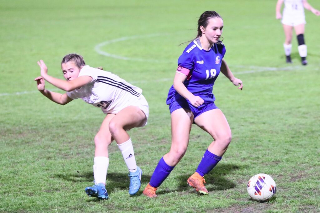 P.K. Yonge's Sydnie Colaw (18) bumps a Maclay (Tallahassee) player to get the ball. Photo by C.J. Gish