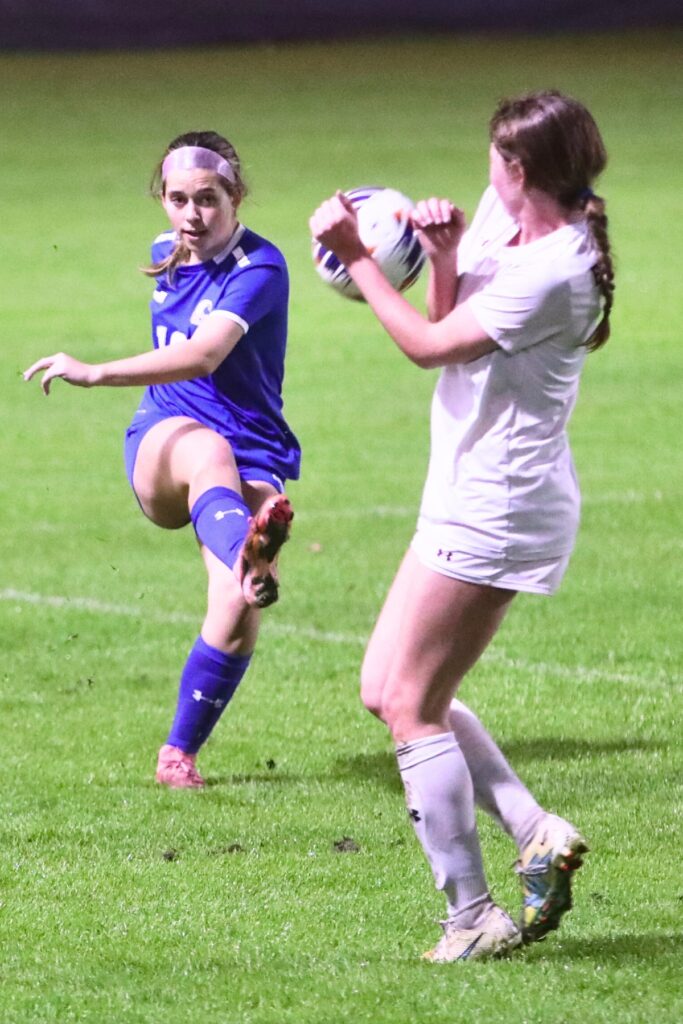 P.K. Yonge's Taylor Hass (16) kicks the ball into an Episcopal School of Jacksonville player. Photo by C.J. Gish