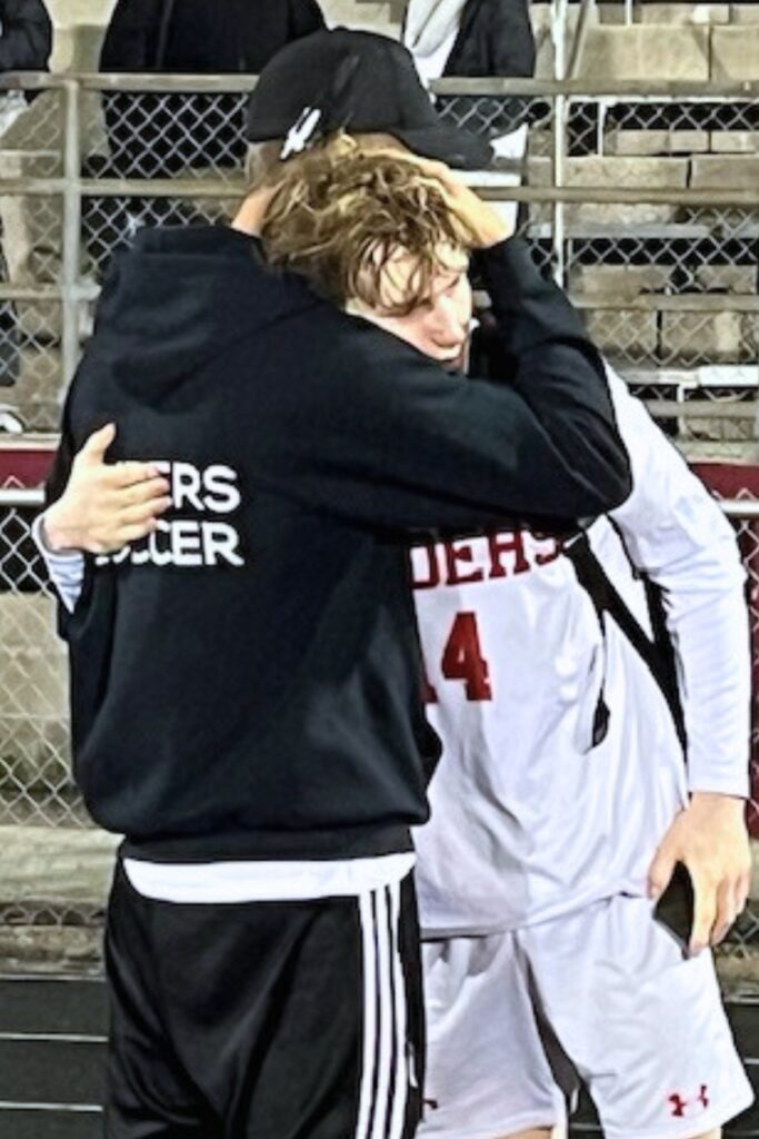 Santa Fe coach Morgan Dall'Acqua hugs Jose Bustamante (4) after a 2-0 loss to Wolfson (Jacksonville).