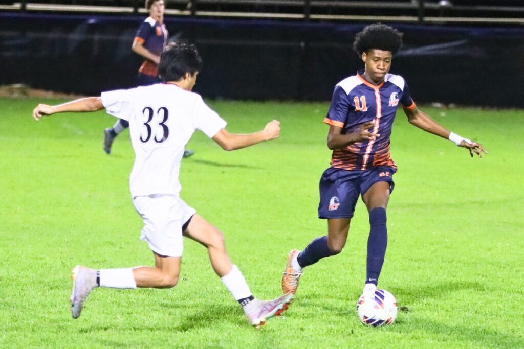 Williston's Adrian Celestino (33) and P.K. Yonge's Davy Coleman (11) go after the ball. Photo by C.J. Gish