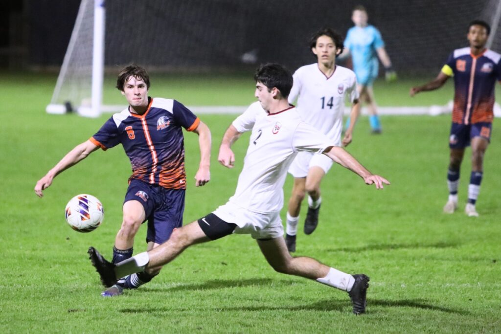 Williston's Braiden Muthard (2) and P.K. Yonge's David Demers (6) go after the ball. Photo by C.J. Gish