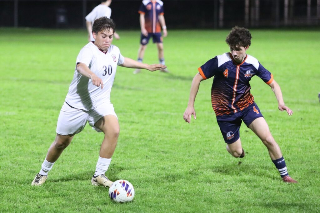 Williston's Cristopher Murillo (30) and P.K. Yonge's Rowan Foley (4) go after the ball. Photo by C.J. Gish
