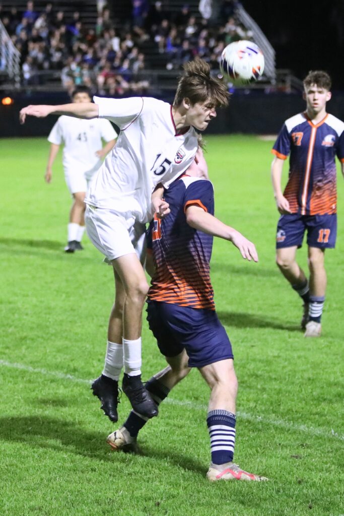 Williston's Daniel Hughes (15) with a header against P.K. Yonge's Jack Reichardt (3). Photo by C.J. Gish