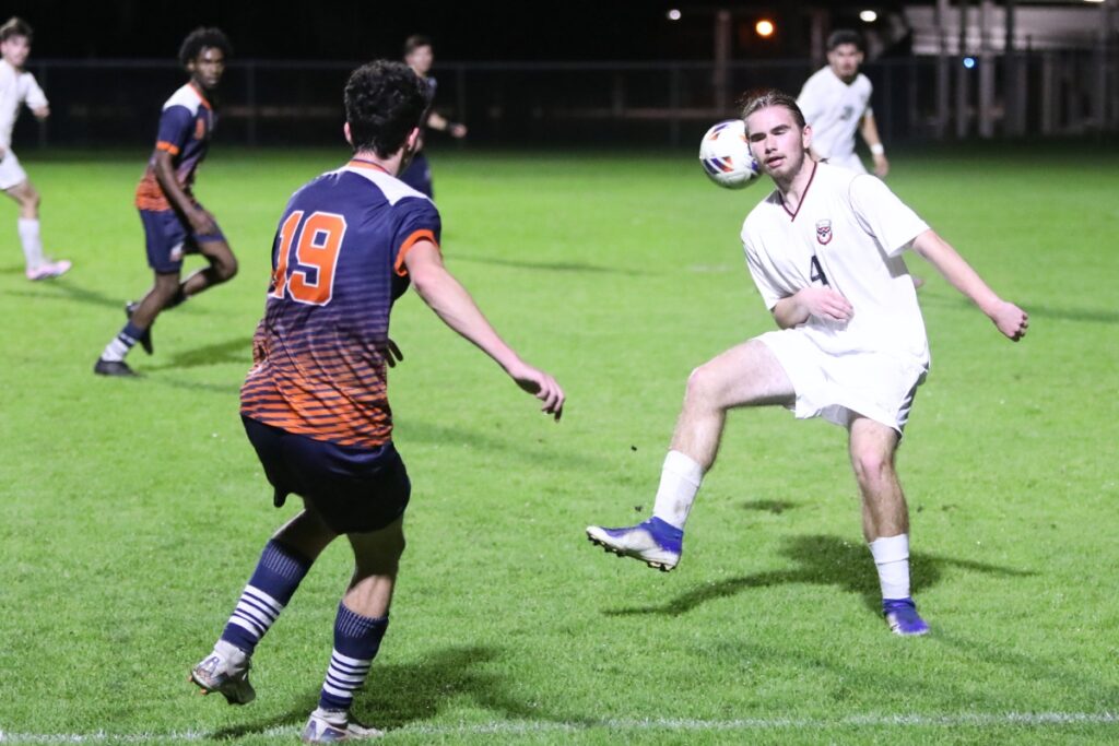 Williston's Edwin Cano (4) with a header against P.K. Yonge. Photo by C.J. Gish