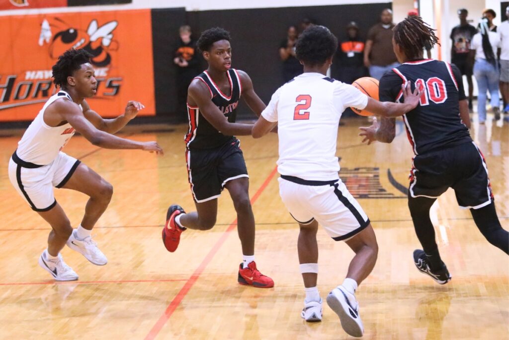 Williston's Giovanni Wright (1) passes the ball to teammate Xavier Kirkpatrick. Photo by C.J. Gish