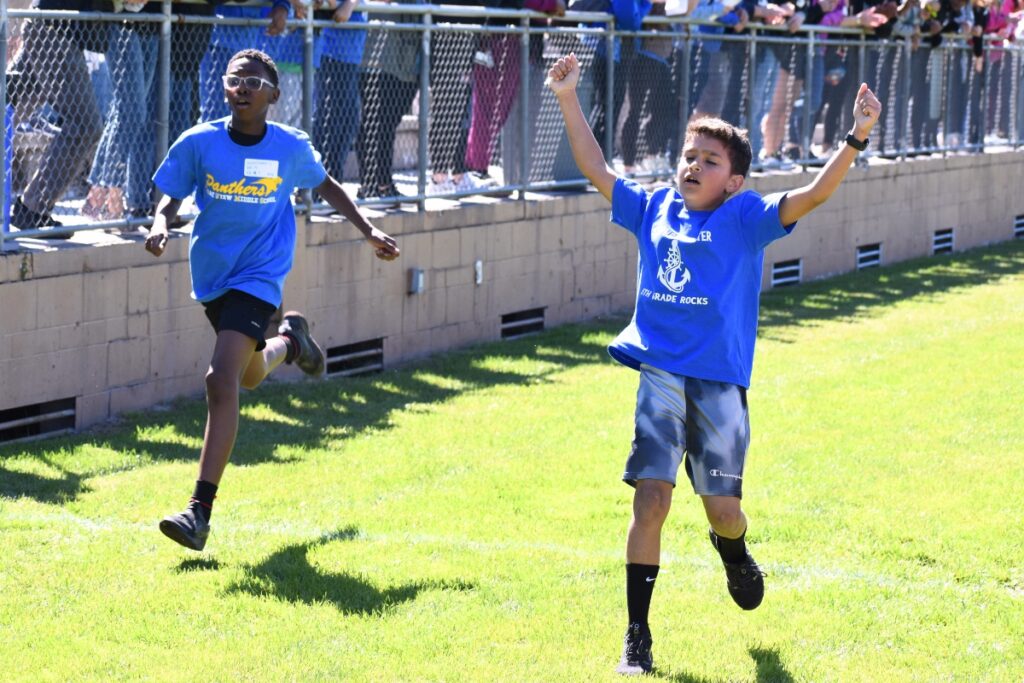 A Stephen Foster Elementary student celebrates as he takes first place in the boys one-mile race. Photo by Glory Reitz