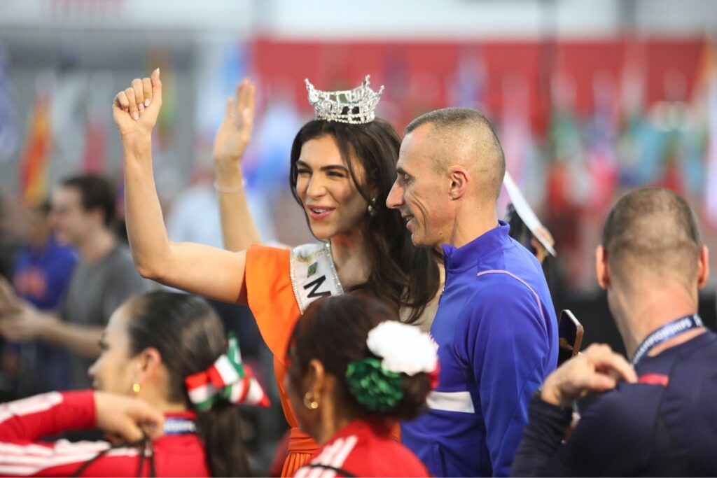 A member of Team France poses with Miss Florida 2024 after the opening ceremony. 