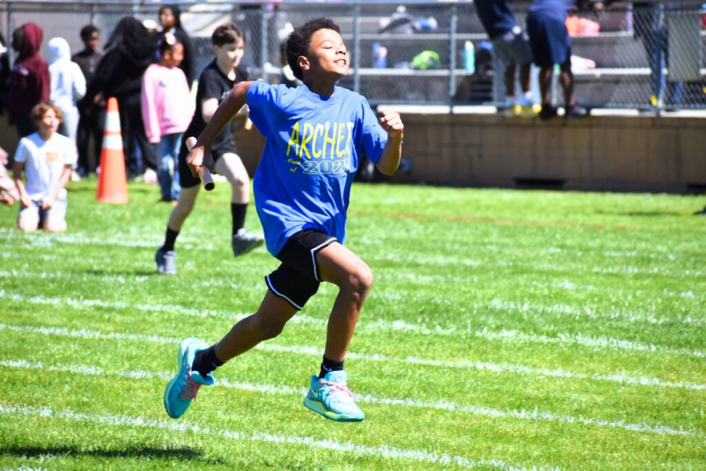 An Archer Elementary student runs in a relay. Photo by Glory Reitz