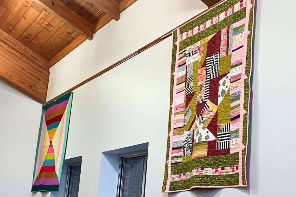Artwork from local quilt guilds hanging on display in the Tower Road Branch library for 2025 Quilt Trail. Photo by Lillian Hamman