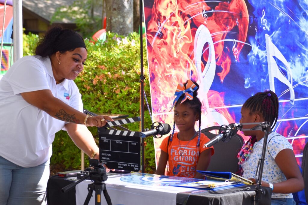 Children try out podcasting at the CTAC opening event. Photo by Glory Reitz
