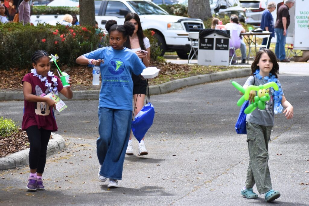 Children walk through the parking lot with their haul of treats during the opening celebrations. Photo by Glory Reitz