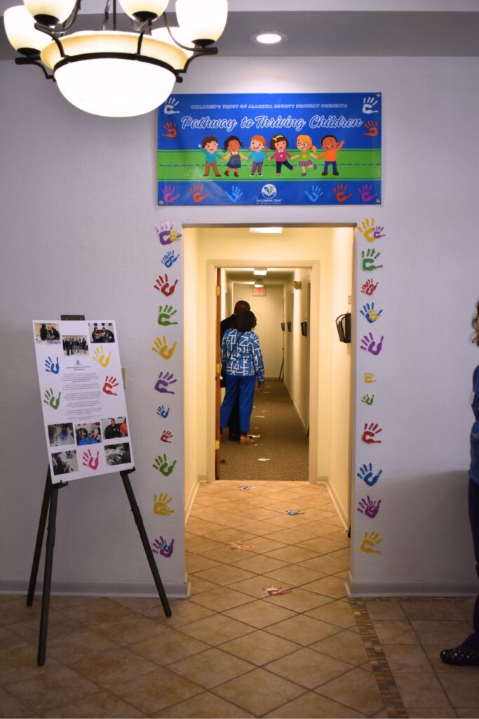 Event attendees follow a Pathway to Thriving Children through the new office building. Photo by Glory Reitz
