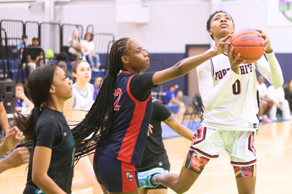 Fort White's Isreal Hart drives to the basket against Vanguard's Sylnya Robertson at The Prep Zone All-Star Showcase. Photo by C.J. Gish