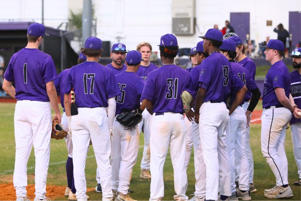 Gainesville coach Adrian Ramos talks to his team between innings against Vanguard in 2025.