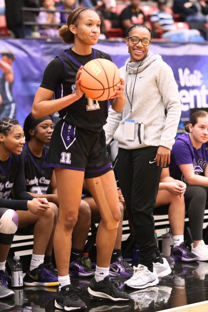 Gainesville coach Jazlynd Rollins (left) all smiles next to Jayden Terry (11) as GHS built a 37-22 lead in the first half against Northeast (Oakland Park) in the Class 5A state semifinals. Photo b