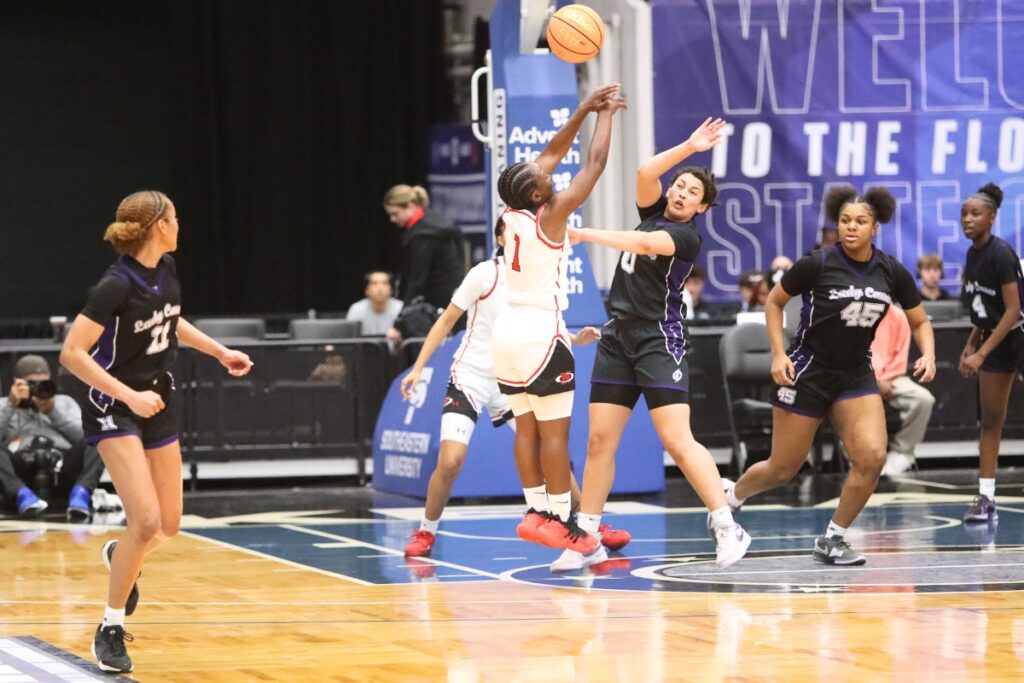 Gainesville's Jamison Cardwell (0) with a pass to Jayden Terry (11) against Northeast (Oakland Park) in the Class 5A state semifinals. Photo by C.J. Gish