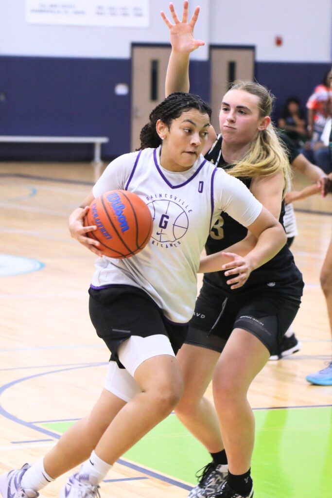 Gainesville's Jamison Cardwell drives to the basket against Trinity Catholic's Sadie Garrett at The Prep Zone All-Star Showcase. Photo by C.J. Gish