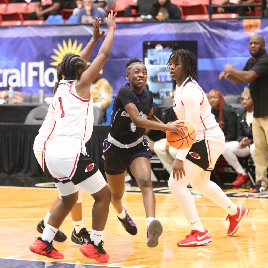 Gainesville's Kendall Ruise (4) drives to the basket against Northeast (Oakland Park) in the Class 5A state semifinals. Photo by C.J. Gish