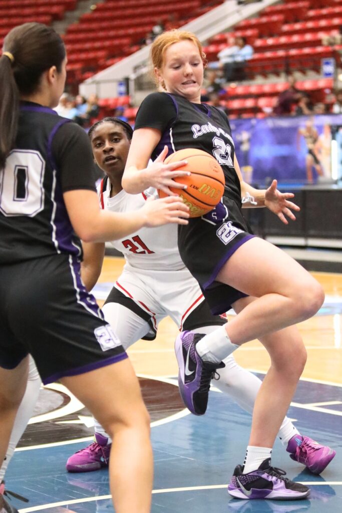 Gainesville's Sarah Collins (21) with a rebound against Northeast (Oakland Park) in the Class 5A state semifinals. Photo by C.J. Gish