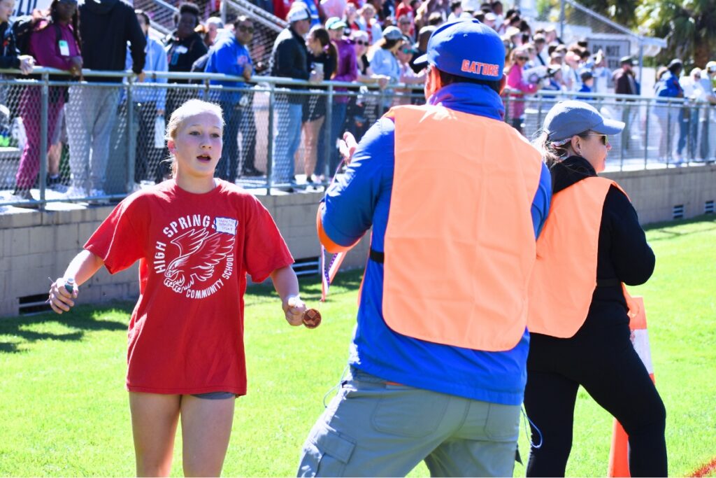 Hadley P. receives her first place medal in the girls one-mile run. Photo by Glory Reitz