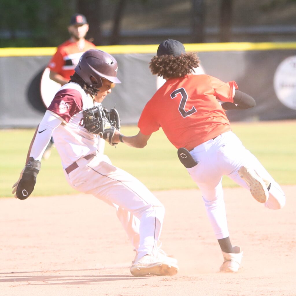 Hawthorne's Branson Byrd tags Oak Hall's Aaron Akins out in a third-inning rundown. Photo by C.J. Gish