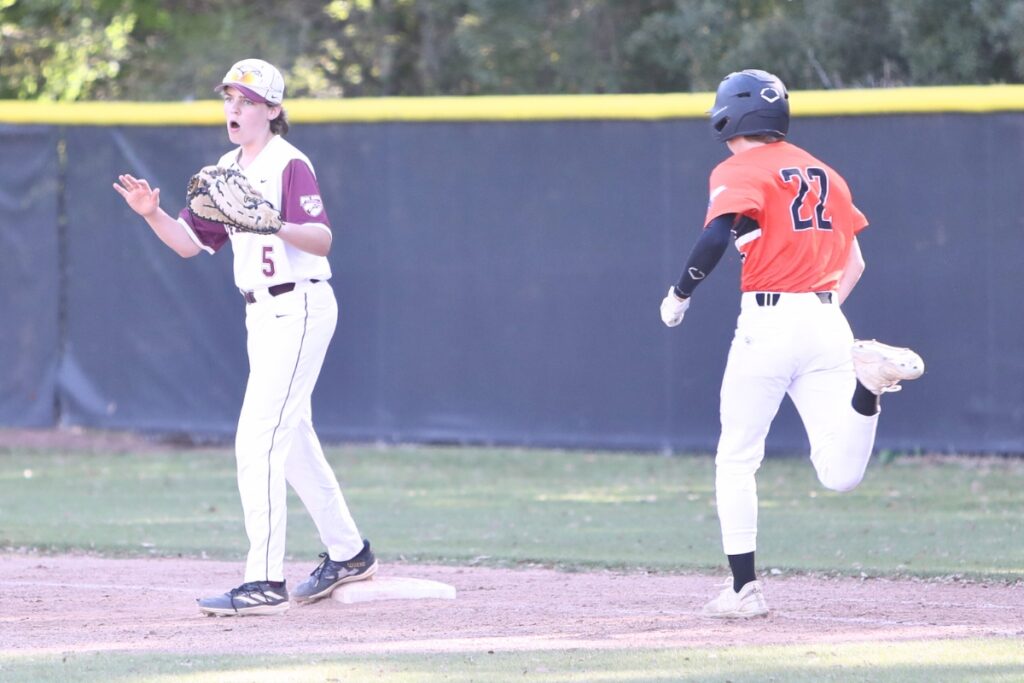 Hawthorne's Jackson Broome (22) hustles to first for a single in the third inning against Oak Hall. Photo by C.J. Gish