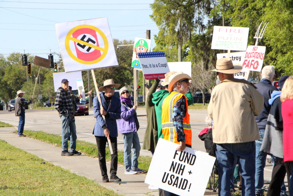 Protesters standing along North Main Street in Gainesville on Saturday.